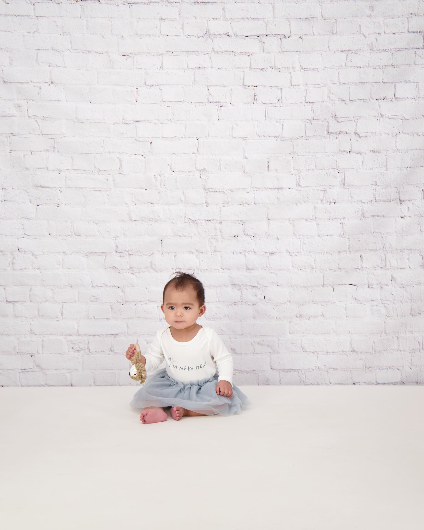 baby sat in slogan onesie and silver bloomer tutu