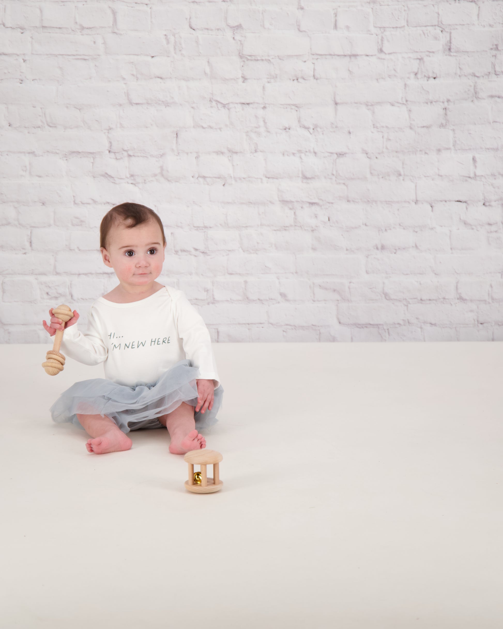 baby sat in slogan onesie and silver bloomer tutu